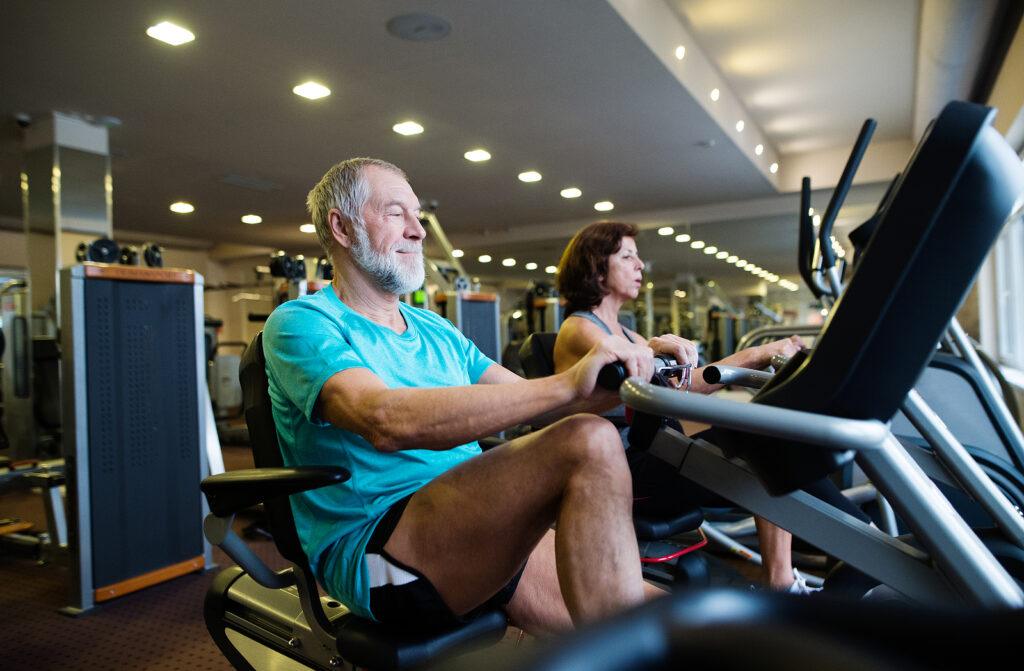 senior on exercise bike