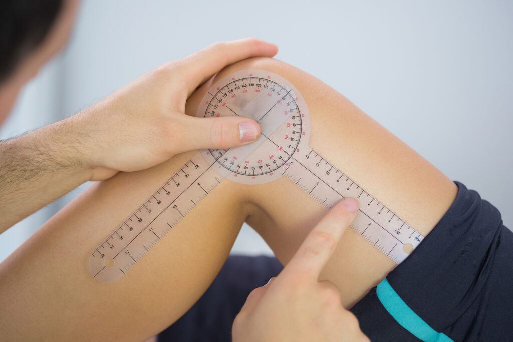 physical therapist using goniometer