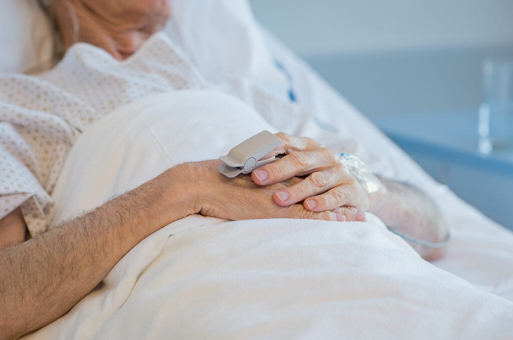 senior lying in hospital bed