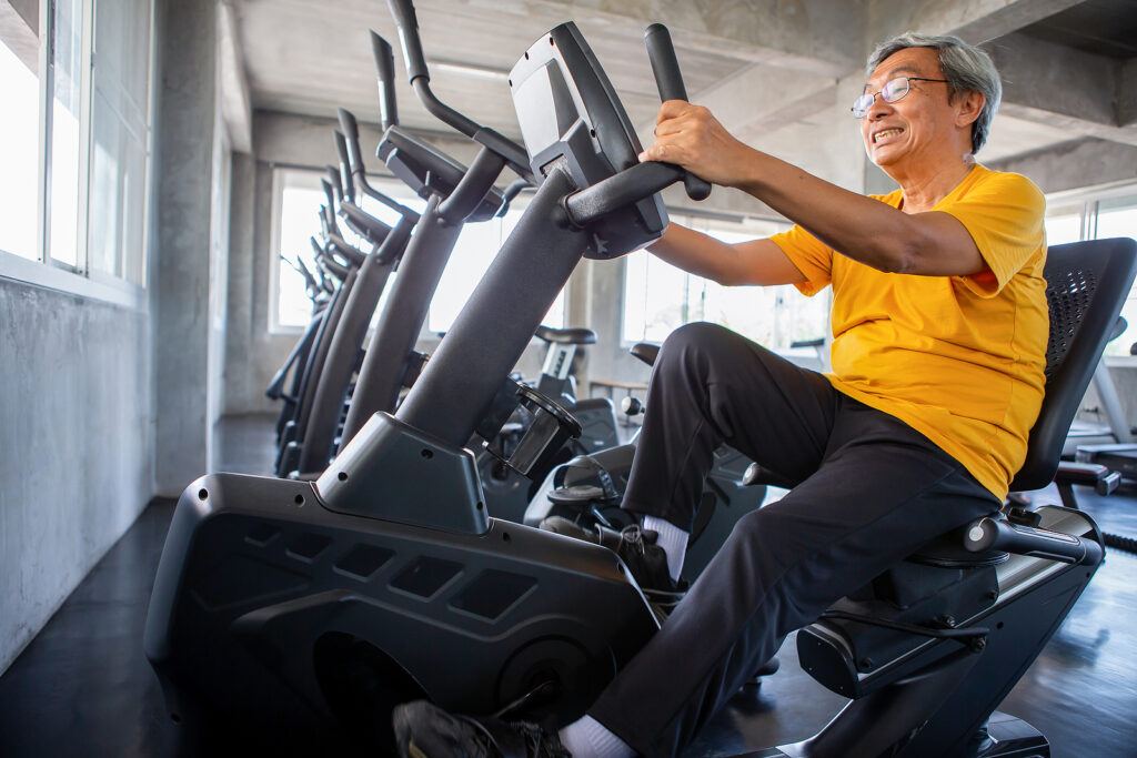 senior using recumbent bike