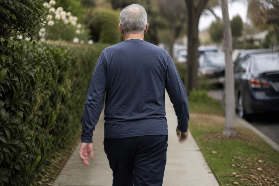 rear view of an older adult walking with both arms swinging in opposite directions